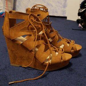 Lace up tan wedges.